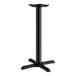 A Lancaster Table & Seating black cast iron counter height table base with a cross-shaped bottom.