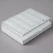 A white plastic box with a clear lid containing American Metalcraft clear acrylic card holders.