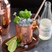 A copper mug with a Boylan Heritage Ginger Beer mixer and ice and mint leaves on it.