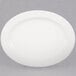 A CAC oval porcelain platter with a white rim on a gray surface.