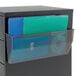 A file cabinet with a clear drawer holding a blue and green folder in a Deflecto magnetic file holder.