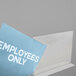 A clear plastic display with a blue sign reading "Employees Only"