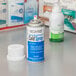 A close up of a white bottle of Medi-First cold spray.
