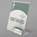 A Deflecto clear slanted sign holder with business card pocket.