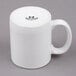 A white Tuxton china mug with black text on it.