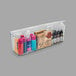 A clear plastic Deflecto stackable caddy organizer with different colored items inside.