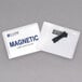 A close-up of a C-Line clear magnetic name badge holder with a black tag inside.