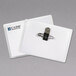 A pair of C-Line clear plastic name badge holders with metal clips and paper inserts.