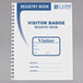A C-Line visitor name badge register book with a pen.