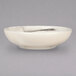 A white porcelain bowl with black swirls on the rim.