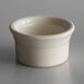 A white Libbey porcelain ramekin on a gray surface.