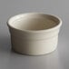A Libbey white porcelain ramekin on a gray surface.