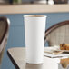 A white Solo paper hot cup on a table.