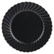 A black plastic plate with a scalloped edge and a swirly design.