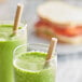 Two glasses of green smoothie with EcoChoice Kraft giant unwrapped paper straws.