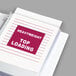 A notebook with a C-Line Heavy Weight Top-Loading Sheet Protector on it.