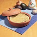 A bowl of tortillas in a Fox Run terra cotta tortilla warmer.