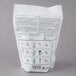 A white plastic bag of Urnex Pakz coffee equipment cleaner with instructions on it.