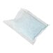 A single white packet of Urnex coffee equipment cleaner.