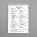 A white sheet of paper with black text inside a clear magnetic sheet protector.