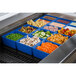 A blue Tablecraft container holding food on a salad bar counter.