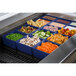 A blue Tablecraft container filled with food on a counter in a salad bar.