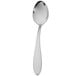 A close-up of a Walco stainless steel demitasse spoon with a white handle.