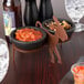 A black plastic HS Inc. 2-way salsa caddy holding bowls of salsa on a table.