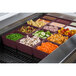 A Tablecraft maroon speckle deep bowl filled with food on a counter in a salad bar.