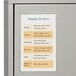 A metal cabinet with a weekly schedule in a C-Line double-sided shop ticket holder.