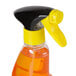 a spray bottle with a yellow and orange liquid