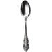 A close-up of a Walco stainless steel tea spoon with an ornate design.