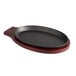 A Choice pre-seasoned cast iron fajita skillet with a mahogany wood underliner.