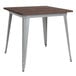 A Flash Furniture square dining table with metal legs and a rustic wood top.