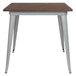 A Flash Furniture square dining table with metal legs and a rustic wood top.