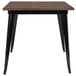 A Flash Furniture table with a black metal base and rustic wood top.