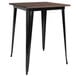 A Flash Furniture bar height table with a black metal frame and a wood top.