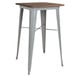 A Flash Furniture bar height table with a silver metal frame and wood top.