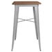A Flash Furniture bar height table with a walnut top and silver metal frame.