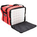 A red and black Rubbermaid insulated delivery bag with pizza boxes inside.