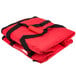 A red Rubbermaid insulated delivery bag with black straps.
