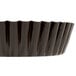 A black non-stick fluted tart pan with a removable bottom.