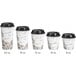 A row of white paper coffee cups with brown bean designs and black lids.