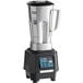 A silver and black Waring TBB160S6 Torq 2.0 blender with a digital display on top.