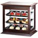 A Cal-Mil wood bakery display case with food on it.
