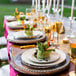 A table set with 10 Strawberry Street silver beaded rim glass charger plates and glasses.