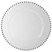 A 10 Strawberry Street white glass charger plate with silver beaded rim.