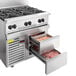 A large stainless steel Vulcan gas range with an open drawer.