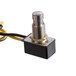 A close-up of a Lavex push switch with black and yellow wires.