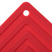 A red silicone pot holder with a square pattern and the Lodge logo in the middle.